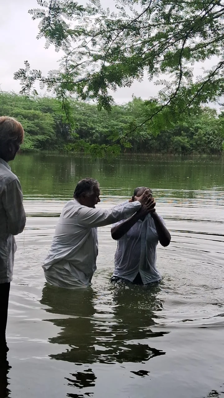 Pastor John baptizing a brother in a lake outside Vellore
